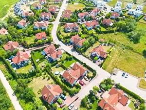 Aerial of new construction luxury residential neighborhood street single family homes real estate