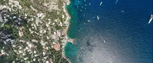 Noon Prints: Aerial overhead drone panoramic shot of southern Capri Island coastline with yachts in summer noon