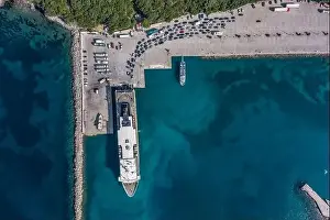 Cephalonia Prints: Aerial overhead drone shot of cars embarking on big cruise ship at Poros town harbour of Kefalonia Island