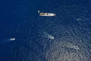 Faraglioni Prints: Aerial overhead drone shot of luxury yacht in Tyrrhenian sea near Capri Island in summer