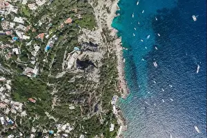 Anacapri Prints: Aerial overhead drone shot of mountain top villa with pool above big mountain hole cave in south Capri Island