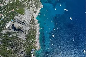 Noon Prints: Aerial overhead drone shot of southern Capri Island coastline with mountain top pool and big hole underneath