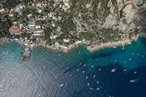 Anacapri Prints: Aerial overhead drone shot of southern Capri Island coastline with yachts in summer noon