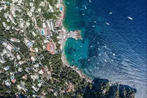 Anacapri Prints: Aerial overhead drone shot of southern Capri Island coastline with yachts in summer noon