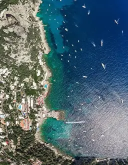 Noon Prints: Aerial overhead drone shot of southern Capri Island coastline with yachts in summer noon