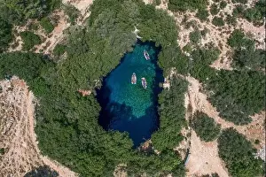 Gods View Prints: Aerial overhead drone shot of tourists boat in subterranean Melissani Lake Cave in Kefalonia Island