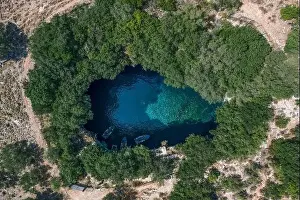 Gods View Prints: Aerial overhead drone shot of tourists boat in subterranean Melissani Lake Cave in Kefalonia Island