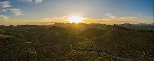 Aerial Panorama Prints: Aerial panorama over the Arizona desert during sunset with mountains and a meandering dry stream