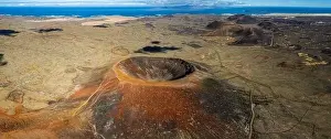 Volcanic Rock Prints: Aerial panorama capturing the vastness of a volcanic terrain with a prominent crater and textured ground