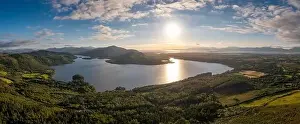 Kerry Prints: An aerial panorama of Caragh Lake in County Kerry with the sun setting over the lake