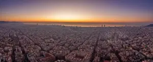 Before Sunrise Prints: Aerial panorama drone shot of Barcelona with sunrise over sea horizon in Spain winter dawn