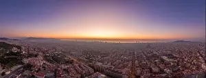 Before Sunrise Prints: Aerial panorama drone shot of Barcelona with sunrise over sea horizon in Spain winter dawn