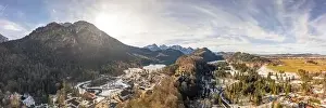 Snow Mountain Prints: Aerial panorama drone shot of Hohenschwangau by lake in Fussen with view of Alps snow mountain range in Germany winter