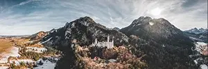Fussen Prints: Aerial panorama drone shot of picturesque Neuschwanstein Castle on snowy hill in winter sunlight in Germany