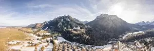 Fussen Prints: Aerial panorama drone shot of picturesque Neuschwanstein Castle on snowy hill in winter sunlight in Germany