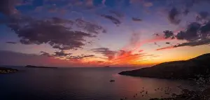 Burning Clouds Prints: Aerial panorama drone shot of sunset burning sky clouds on Komiza town over Vis Island in Croatia Summer