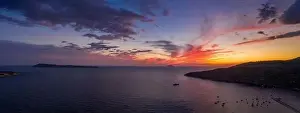 Burning Clouds Prints: Aerial panorama drone shot of sunset burning sky clouds on Komiza town over Vis Island in Croatia Summer