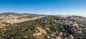 Radio Tower Prints: Aerial panorama drones shot of park on hill outside Barcelona city in Spain winter morning