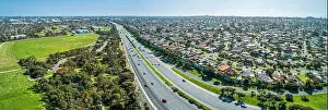 Aerial panorama of highway passing through suburban area on a sunny day in Melbourne, Australia
