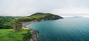 Aerial panorama of the Minard Castle situated on the rocky beach of the Dingle Peninsula with views across the Irish