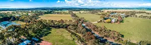 Gum Trees Prints: Aerial panorama of road, meadows and pastures on bright summer day in Australia
