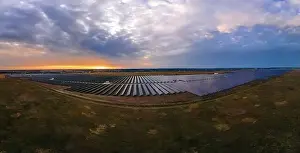 48mp Prints: Aerial panorama view of large solar panels at a solar farm at bright summer sunset