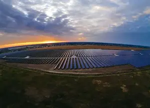 48mp Prints: Aerial panorama view of large solar panels at a solar farm at bright summer sunset