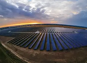48mp Prints: Aerial panorama view of large solar panels at a solar farm at bright summer sunset