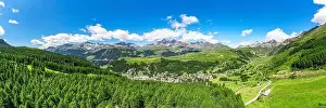 Surrounded Prints: Aerial panoramic of the alpine village of Madesimo surrounded by green woods