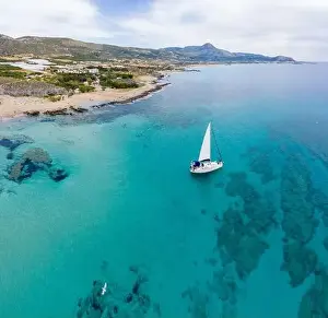 Deep Drone Prints: Aerial panoramic drone top view photo of sail boat sailing in mediterranean Aegean island of Crete Greece in summer