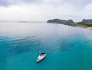 Deep Drone Prints: Aerial panoramic drone top view photo of sail boat sailing in mediterranean Aegean island of Crete Greece in summer