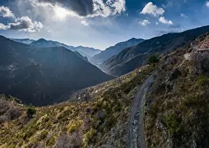 Drone Landscape Prints: Aerial panoramic drone view of a scenic highway by the beautiful Landscape covered in clouds and fog