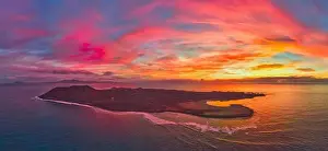 Lobos Prints: Aerial panoramic image of a dramatic sunrise over Lobos island Corralejo Fuerteventura