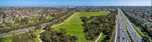 Mulgrave Prints: Aerial panoramic landscape of cars driving on highway passing through typical suburban landscape in Melbourne