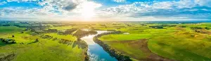 Aerial panoramic landscape of scenic sunset over river and grasslands in Australia
