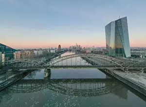 Reflex Prints: Aerial panoramic picture of Deutschherrnbrücke with Frankfurt skyline during sunrise in winter