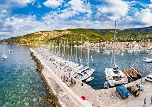 Azure Water Prints: Aerial panoramic view of city Komiza - the one of numerous port towns in Croatia