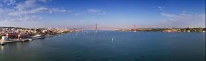 Aerial panoramic view of the city of Lisbon with sail boats on the Tagus River and the 25 of April Bridge
