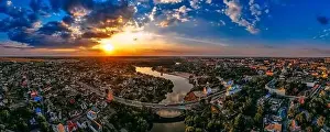 Aerial panoramic view of of small european city placed on river banks at summer sunny day with clouds