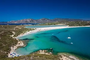 Aerial done panoramic view of Porto Giunco beach and tower in Villasimius, Sardinia, Italy