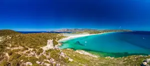 Aerial done panoramic view of Porto Giunco beach and tower in Villasimius, Sardinia, Italy