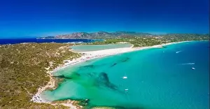 Aerial done panoramic view of Porto Giunco beach and tower in Villasimius, Sardinia, Italy