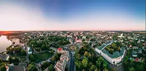 Aerial panoramic view of roundabout road with circular cars in small european city at cloudy autumn day