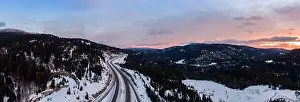 Merritt Prints: Aerial Panoramic View of a scenic Highway passing in the Canadian Mountain Landscape during a colorful winter sunrise