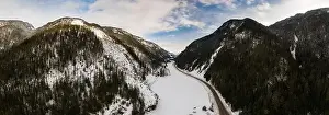 Revelstoke Prints: Aerial Panoramic View of a scenic Highway in the valley between Canadian Mountain Landscape in winter