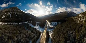 Revelstoke Prints: Aerial Panoramic View of a scenic Highway in the valley between Canadian Mountain Landscape during winter sunny sunset