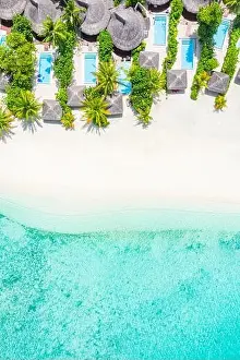 Aerial photo of beautiful Maldives paradise tropical beach. Amazing view, blue turquoise lagoon water, palm trees and white sandy beach. Luxury travel