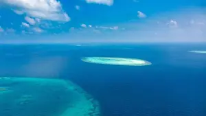 Aerial photo of beautiful paradise Maldives tropical beach on island. Coral reef around atolls, amazing nature. Summer and travel vacation concept