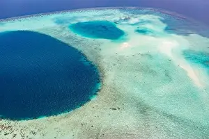Aerial photo of beautiful paradise Maldives tropical beach on island. Coral reef around atolls, amazing nature. Summer and travel vacation concept