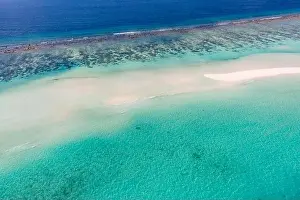 Aerial photo of beautiful paradise Maldives tropical beach on island. Coral reef around atolls, amazing nature. Summer and travel vacation concept